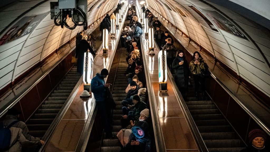 Civilians shelter inside a metro station during an air raid alert in the centre of Kyiv